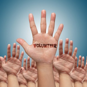 volunteer group raising hands